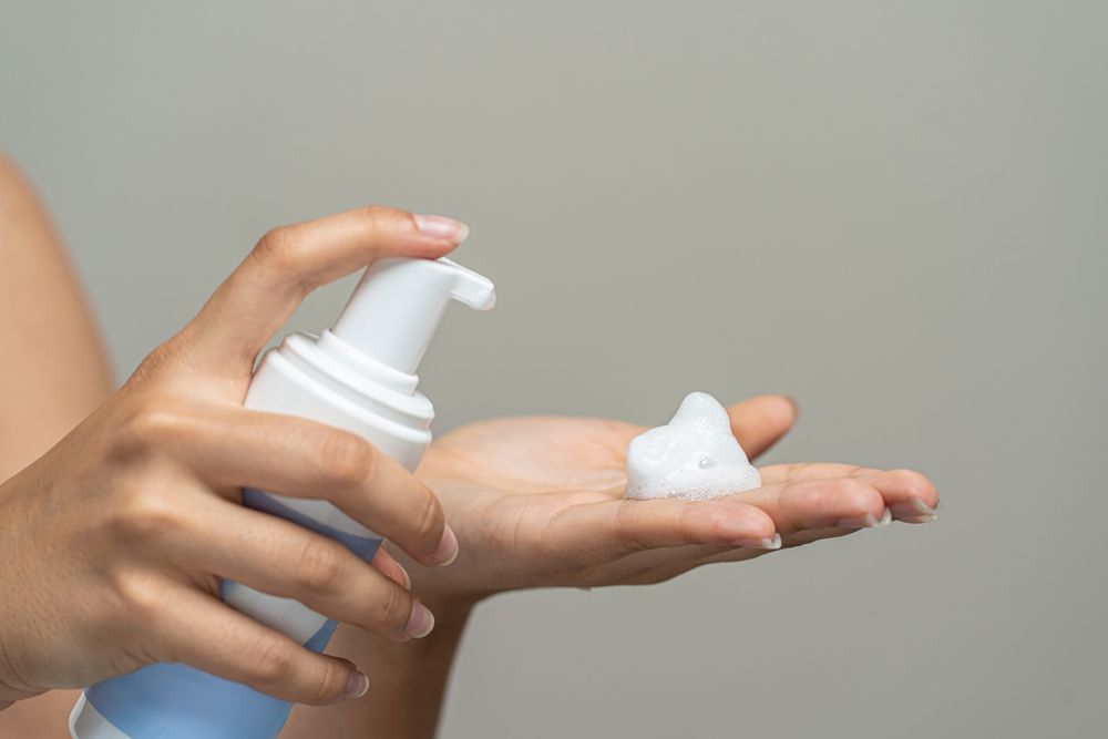person applying product using foamer pump