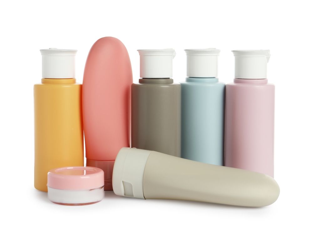 various packaging in varying colors including cylinder rounds with dispensing caps and a tottle style bottle.